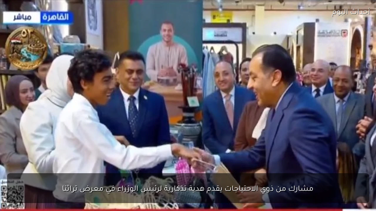 مشارك من ذوي الاحتياجات يقدم هدية تذكارية لرئيس الوزراء في معرض تراثنا