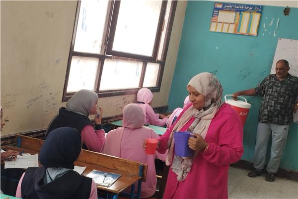 مديرة مدرسة في قنا تقدم مياه مثلجة للطلاب خلال الامتحانات